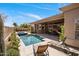 Inviting outdoor pool with tanning chairs, covered patio, and beautiful landscaping at 34463 N 99Th Way, Scottsdale, AZ 85262