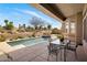 Beautiful outdoor pool area with patio seating and desert landscaping at 34463 N 99Th Way, Scottsdale, AZ 85262