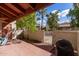 Private backyard brick patio, bordered by a wall and trees, featuring an outdoor grill at 3535 W Monte Cristo Ave # 115, Phoenix, AZ 85053