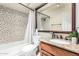 Well-lit bathroom featuring decorative tile, large mirror, granite countertop, and wood vanity cabinet at 3535 W Monte Cristo Ave # 115, Phoenix, AZ 85053