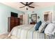 Primary bedroom featuring a ceiling fan, dresser, and a door leading to the bathroom at 3535 W Monte Cristo Ave # 115, Phoenix, AZ 85053