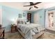 Bright primary bedroom featuring a ceiling fan, side table, bookshelf, and light blue walls at 3535 W Monte Cristo Ave # 115, Phoenix, AZ 85053