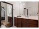 Bathroom features double vanity with decorative mirror and warm lighting at 40142 W Coltin Way, Maricopa, AZ 85138