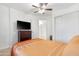 Bright bedroom with ceiling fan, closet, and doorway visible in background at 40142 W Coltin Way, Maricopa, AZ 85138