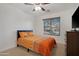 Cozy bedroom featuring a ceiling fan and a dresser, providing ample storage space at 40142 W Coltin Way, Maricopa, AZ 85138