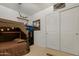 Cozy bedroom with carpeted floors, a tented bed, and closet with sliding doors at 40142 W Coltin Way, Maricopa, AZ 85138