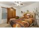 Bedroom featuring a plush bed, matching wood furniture and neutral decor at 40142 W Coltin Way, Maricopa, AZ 85138