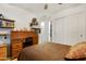 Comfortable bedroom featuring a wooden rolltop desk, shelves and closet at 40142 W Coltin Way, Maricopa, AZ 85138