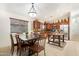 Open dining area with dark table, kitchen with stainless appliances at 40142 W Coltin Way, Maricopa, AZ 85138