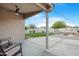 Covered patio with ceiling fan and an expansive backyard with a fire pit at 40142 W Coltin Way, Maricopa, AZ 85138