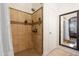 Shower features decorative tile, a built-in seat, and a rainfall shower head at 40142 W Coltin Way, Maricopa, AZ 85138