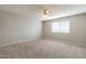 Spacious bedroom with neutral walls, carpet flooring, ceiling fan, and a bright window at 4126 E Carmel Ave, Mesa, AZ 85206