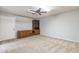 Bedroom features a ceiling fan, carpeted floor, and a built-in media center and cabinet at 4126 E Carmel Ave, Mesa, AZ 85206