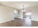 Open concept dining area featuring wood floors, a chandelier, and access to the kitchen at 4126 E Carmel Ave, Mesa, AZ 85206