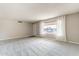 Bright living room featuring large windows, neutral carpet and fresh paint at 4126 E Carmel Ave, Mesa, AZ 85206