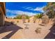 Private backyard oasis featuring desert landscaping, a seating area, and mature trees for outdoor enjoyment at 41304 W Rio Bravo Dr, Maricopa, AZ 85138