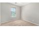 Bedroom with large window, carpet flooring, and neutral walls at 41304 W Rio Bravo Dr, Maricopa, AZ 85138