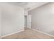 Bedroom featuring neutral walls, carpet flooring, and a door to the hallway at 41304 W Rio Bravo Dr, Maricopa, AZ 85138