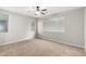 Bright, carpeted bedroom with neutral walls and natural light from several windows at 41304 W Rio Bravo Dr, Maricopa, AZ 85138