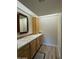 Bathroom featuring a vanity with tile countertop, wooden cabinets, and modern flooring at 4200 N Miller Rd # 321, Scottsdale, AZ 85251