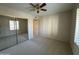 Spacious bedroom featuring ample closet space and neutral carpeting at 4200 N Miller Rd # 321, Scottsdale, AZ 85251