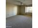 Spacious bedroom with plush carpeting and a window overlooking a balcony at 4200 N Miller Rd # 321, Scottsdale, AZ 85251