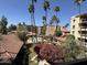 Balcony view of the complex, including palm trees, pool and lush landscaping at 4200 N Miller Rd # 321, Scottsdale, AZ 85251