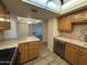 Kitchen with wood cabinets, tile countertops, and stainless steel dishwasher at 4200 N Miller Rd # 321, Scottsdale, AZ 85251