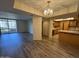 Spacious living room adjacent to a kitchen, with a balcony and wood floors at 4200 N Miller Rd # 321, Scottsdale, AZ 85251