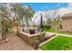 Inviting backyard features an outdoor seating area, complemented by lush greenery and mature trees at 4266 S Winter Ln, Gilbert, AZ 85297