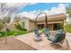 Picturesque backyard with a seating area, bordered by verdant lawn and beautiful landscaping at 4266 S Winter Ln, Gilbert, AZ 85297