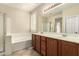 Bathroom featuring double vanity, soaking tub, and shower at 4266 S Winter Ln, Gilbert, AZ 85297