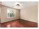 Bedroom featuring wood floors and plantation shutters at 4266 S Winter Ln, Gilbert, AZ 85297