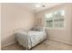 Cozy bedroom featuring a white metal bed frame and bright natural light from the shuttered window at 4266 S Winter Ln, Gilbert, AZ 85297