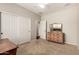 Bedroom showcasing closet doors and vintage dresser with mirror, complete with neutral walls and carpet at 4266 S Winter Ln, Gilbert, AZ 85297