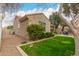 Exterior view of a well-kept home with a private backyard and lush landscaping at 4266 S Winter Ln, Gilbert, AZ 85297