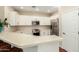 Kitchen featuring stainless steel appliances and countertop breakfast bar seating at 4266 S Winter Ln, Gilbert, AZ 85297