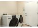 Laundry room featuring modern washer and dryer units, with easy access to the outdoors at 4266 S Winter Ln, Gilbert, AZ 85297