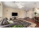 Spacious living room featuring hardwood floors, a ceiling fan, and a gray sofa at 4266 S Winter Ln, Gilbert, AZ 85297