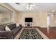 Spacious living room featuring hardwood floors, a ceiling fan, and a large window at 4266 S Winter Ln, Gilbert, AZ 85297