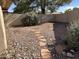 Backyard featuring rock landscaping and shrubbery with a small stone pathway at 4537 E Shomi St, Phoenix, AZ 85044