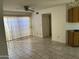 Bright living room featuring tile floors, a ceiling fan, and sliding doors to the backyard at 4537 E Shomi St, Phoenix, AZ 85044