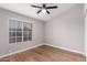 Bedroom featuring a bright window with horizontal blinds and wood-look flooring at 4537 E Towne Ln, Gilbert, AZ 85234