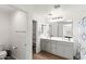 Bright bathroom with double vanity, large mirror, and wood look flooring at 5811 W Encinas Ln, Phoenix, AZ 85043