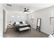 Primary bedroom features a ceiling fan, neutral carpet, and bright windows at 5811 W Encinas Ln, Phoenix, AZ 85043