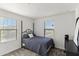 Bedroom with a black bed frame, neutral carpet, and bright natural light at 5811 W Encinas Ln, Phoenix, AZ 85043