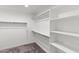 Walk-in closet with metal racks for hanging clothes and shelves for storage at 5811 W Encinas Ln, Phoenix, AZ 85043