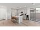 Bright kitchen with white cabinets, stainless appliances, and island with barstool seating at 5811 W Encinas Ln, Phoenix, AZ 85043