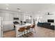 Modern kitchen flows into living room with a center island and stainless appliances at 5811 W Encinas Ln, Phoenix, AZ 85043