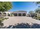 Spacious three-car garage with neutral doors and brick paved driveway, offering ample parking at 5858 E Caballo Dr, Paradise Valley, AZ 85253